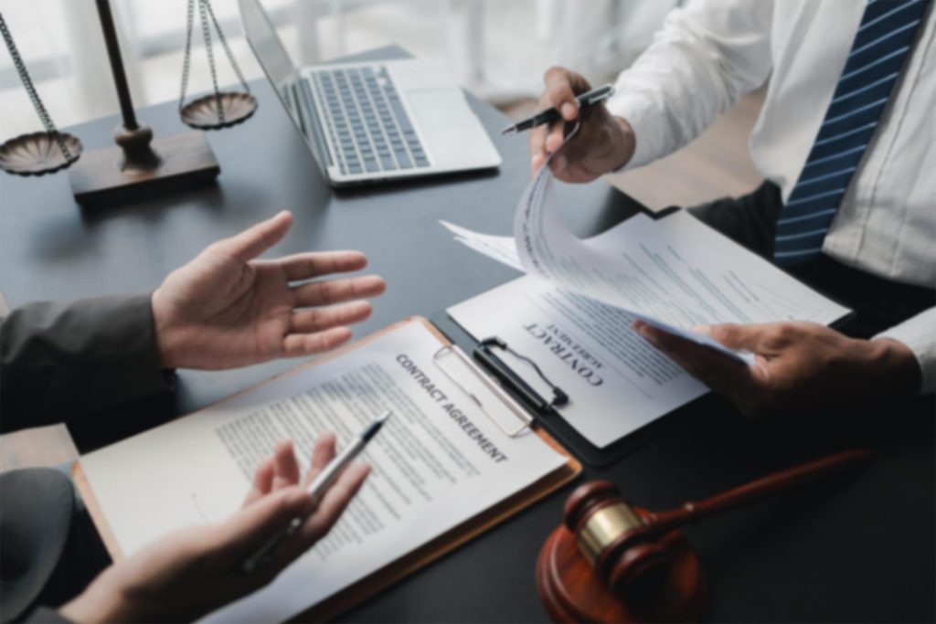 two people going over a contract in an office