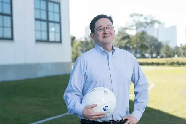 Trent Cotney holding a hard hat.